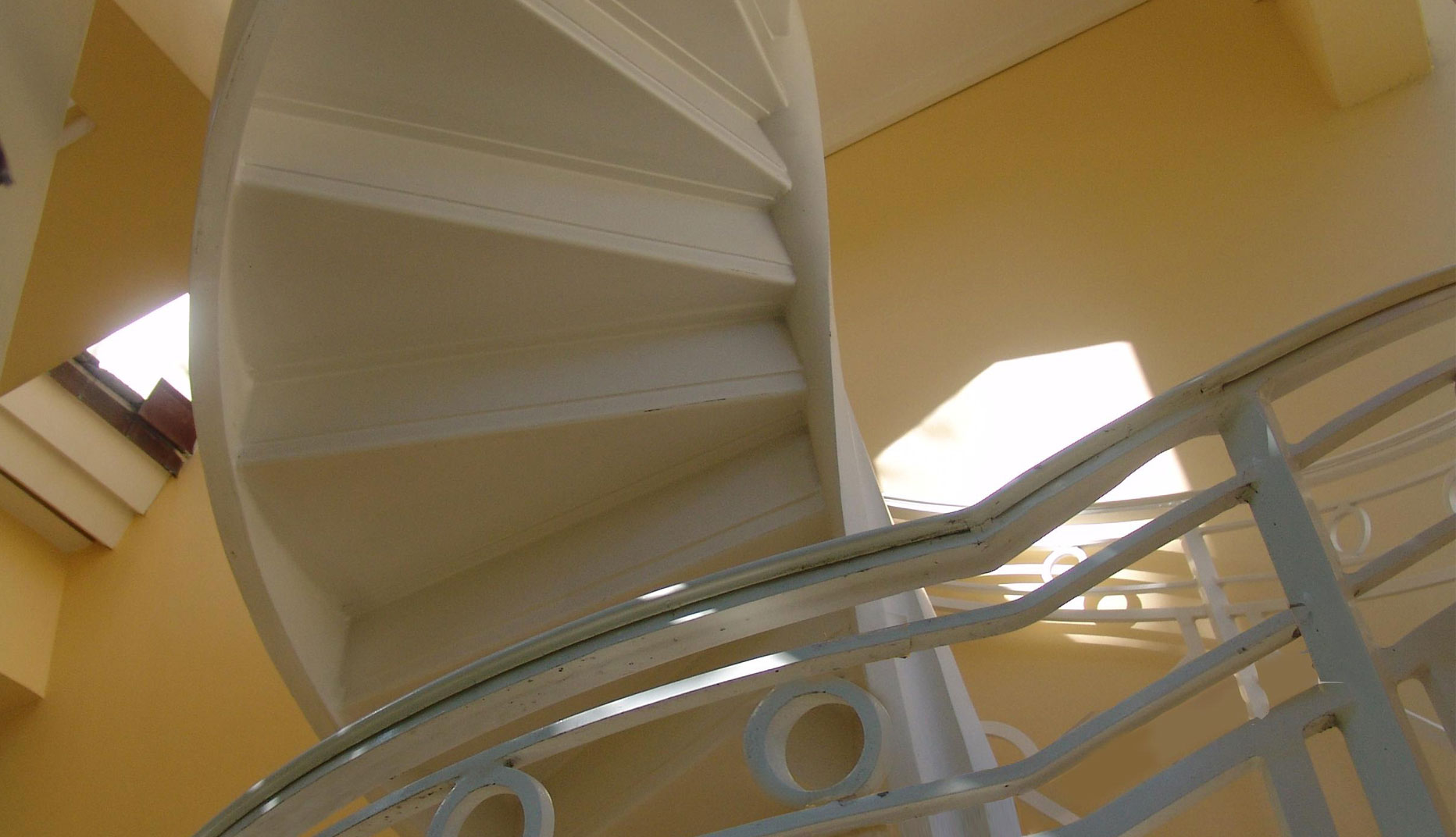 cropped photo of a residential iron spiral staircase